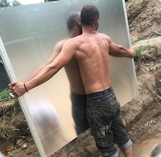 Man carrying a panel for the installation of an inground pool
