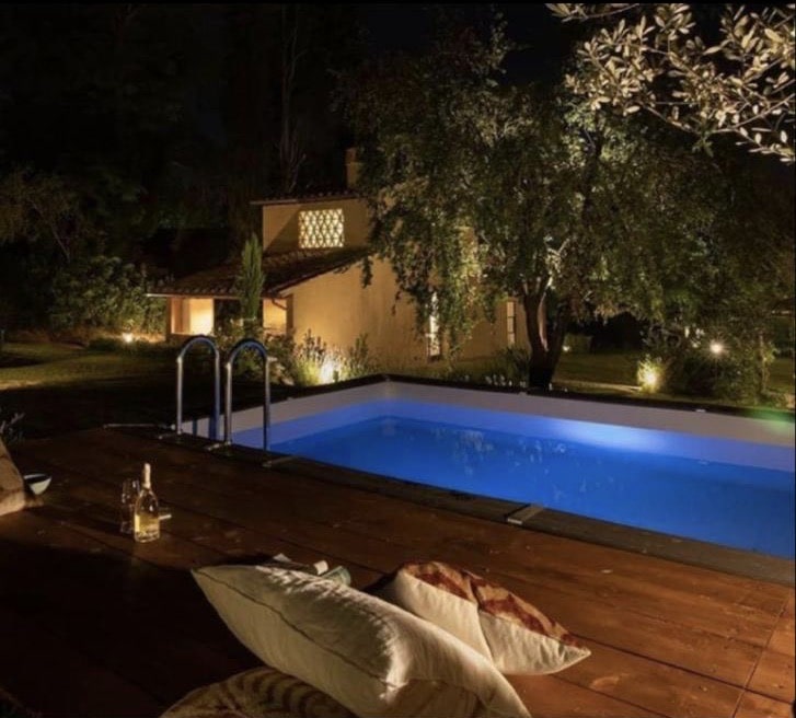 Large rectangular semi-inground pool seen at night